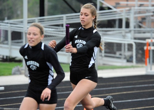 Sam Alexander exchanges with Abbi Curtis in Warsaw's winning 4x100 relay.