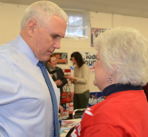 Gov. Mike Pence talks with Lynn Howie, county party chairman, after he arrived at the event.