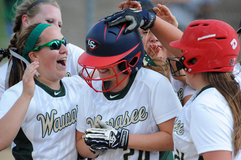 Wawasee's Hannah Haines, center, is mobbed by teammates after hitting her first of three home runs Monday in Wawasee's 6-4 win over Northridge. (Photos by Mike Deak)