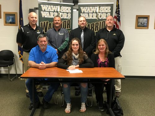 Wawasee High School senior Katlyn Kennedy has signed a letter of intent to continue her track and field career at Manchester University. Seated with Kennedy are parents Gael and Kathleen Conway. In the back row are WHS athletic director Steve Wiktorowski, Wawasee track and field head coach Scott Lancaster, Wawasee High School principal Mike Schmidt, Wawasee track and field throws coach Scot McDowell. (Photo by Mike Deak)