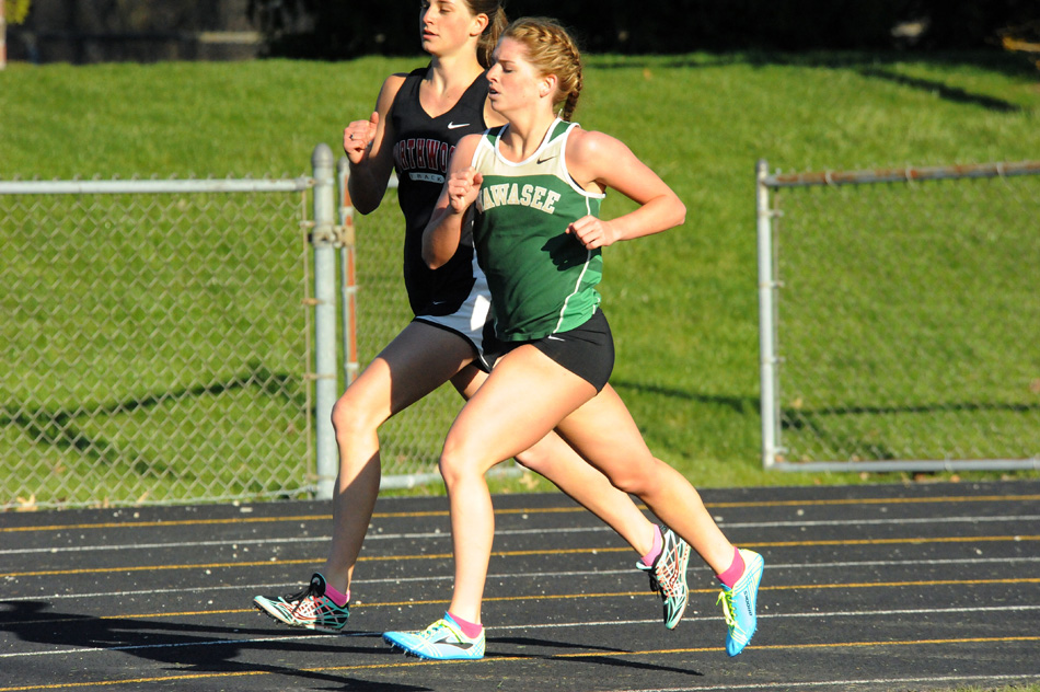 Wawasee's Aubrey Kuhn and NorthWood's Erika Stutzman run stride for stride in the 800-meter run Tuesday afternoon. (Photos by Mike Deak)