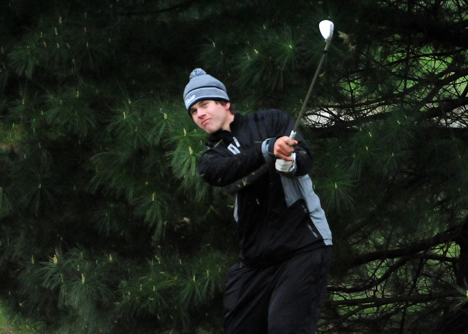 Warsaw's Luke Delp chips onto the eighth green during Saturday's Wawasee Invite. (Photos by Mike Deak)
