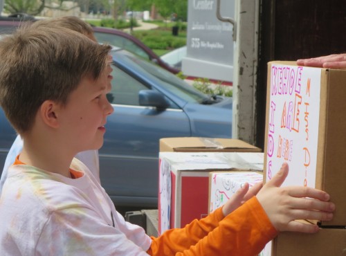 Milford student helps to unload books for the Kehoe Kids Project.