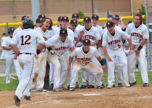 NorthWood players crowd home plate as Brant Mast (12) trots around the bases after his home run. (Photos by Nick Goralczyk)