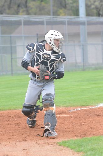 Warsaw catcher Zach Witt checks on a baserunner after taking a throw to the plate.