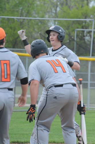 Henry Howard prepares to get greeted by his teammates after hitting one of his two home runs for the Tigers Friday night.