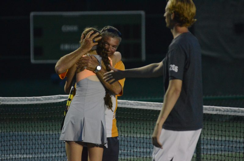 Warsaw girls tennis coach Rick Orban congratulates Colette Smith after winning the regional Wednesday night. Smith won in three sets at No. 2 singles in a match lasting over four hours to give the Tigers a 3-2 win over Plymouth.