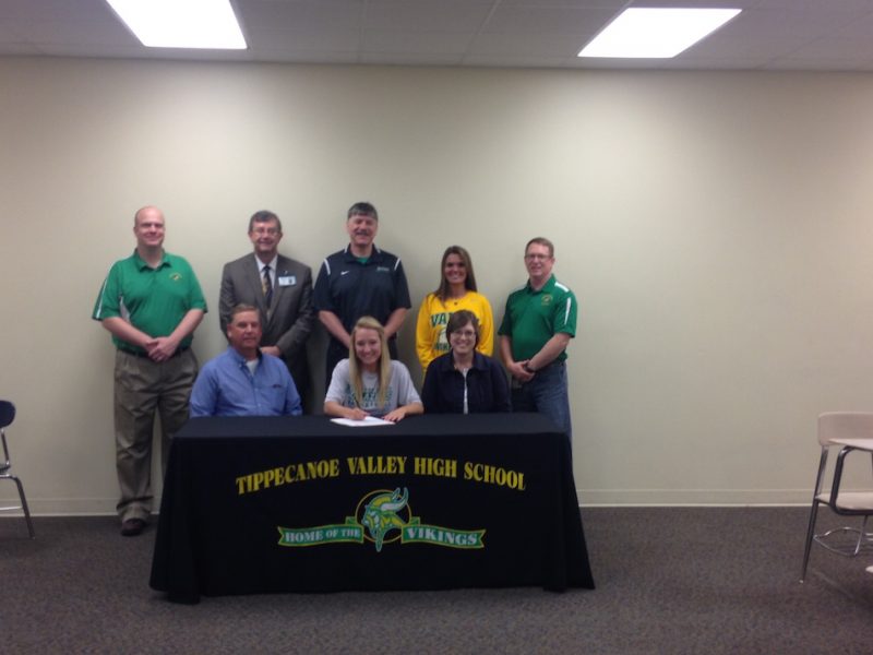 Tippecanoe Valley senior Karis Tucker will play basketball at John Wood Community College. Tucker is shown with her parents Chan and Nicole. In back are TVHS principal Michael Bendiscen, superintendent Brett Boggs, John Wood coach Norman Rodriguez, Valley assistant coach Alissa Trippiedi and Valley assistant athletic director Scott Smith (Photo provided) 