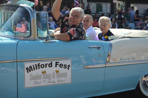 Milford Fest's 2016 Senior King and Queen Bud and Shirley Beer get an escort through town during the annual Memorial Day parade.