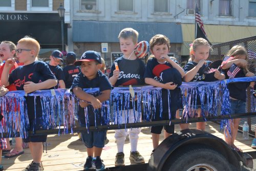Members of the Milford Youth Baseball League enjoy the ride on their float during the 2016 Memorial Day parade.