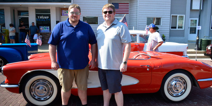 David and Dan Ferguson pose in front of the corvette they would drive in the parade.