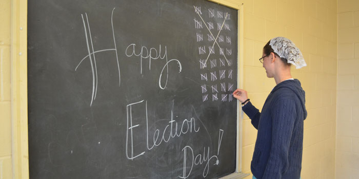 Poll worker Cassia Richardson adds another tally mark to the board at Etna Green's Heritage Park building. (Photos by Amanda McFarland)