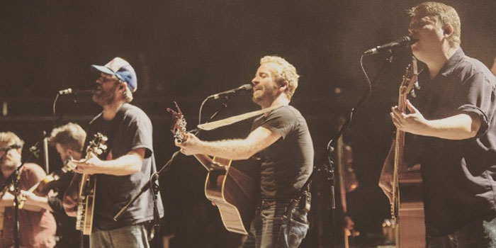 Members of the Trampled By Turtles Eric Berry, Dave Simonett, and Tim Saxhaug perform their music.