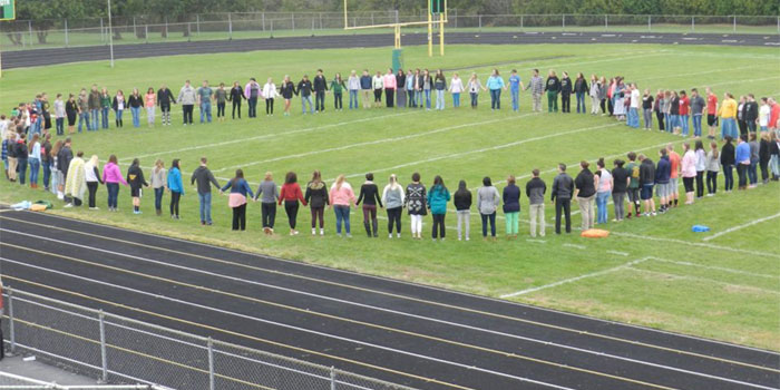 An FCA-led prayer event with the Bibler family, held in October, 2015. The student body gathered in the stands. (Photos provided)