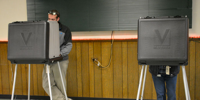 Voters Adam Churchill and Linda Whitaker cast their ballots at the Moose Lodge.