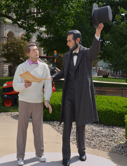"Return Visit" stands at the official site of the Walk-n-Wander unveiling. The man in the sweater is reading the Gettysburg Address.