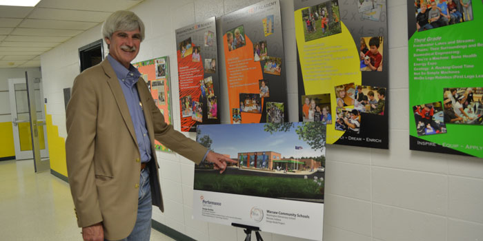 Jim Lemasters shows off a rendering of what Washington school will look like when construction is finished.