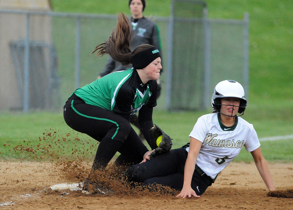 Wawasee's Cristina DeLaFuente slides under the tag attempt of Concord's Skylar Decker to complete a two-run triple. 
