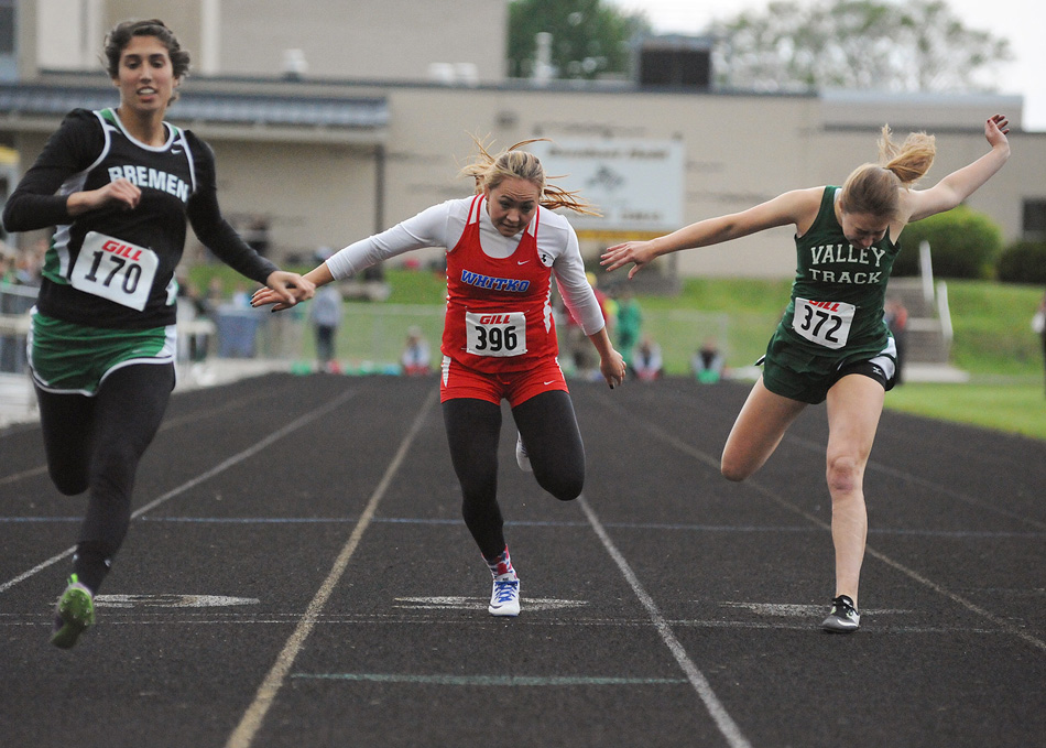 Whitko's Kaitlyn Reed, center, and Tippecanoe Valley's Sarah Tucker lunge for the finish line during the 100-meter dash finals at Tuesday's Rochester Girls Track Sectional. Tucker got Reed by .01 and the final guaranteed regional berth in the event. (Photos by Mike Deak)