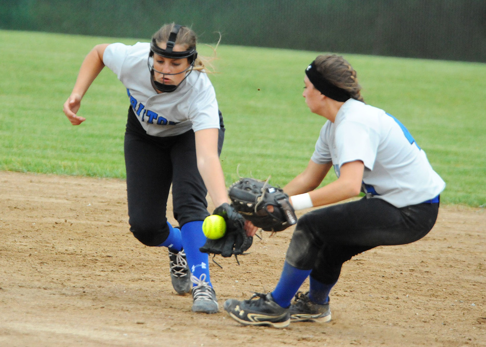 Nicole Sechrist converges with Kayla Kreft trying to field a ball at South Central Tuesday in the Class 1-A softball regional. South Central would repeat as regional champion with an 11-2 win. (Photos by Mike Deak)