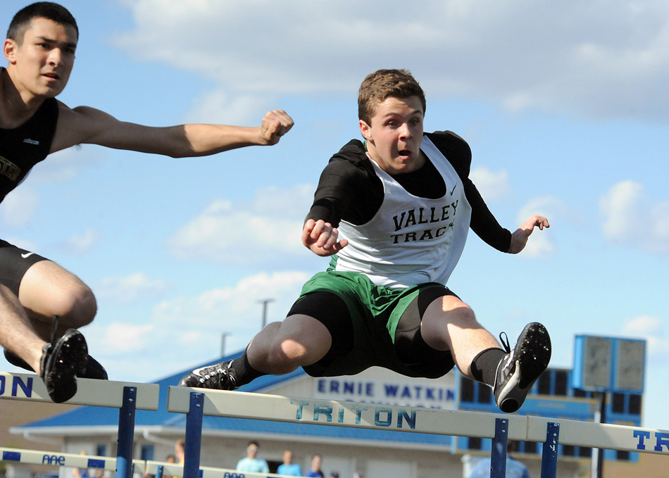 Travis Shull of Tippecanoe Valley clears the low hurdles in the 100 hurdles event Tuesday against Rochester and Triton. (Photos by Mike Deak)