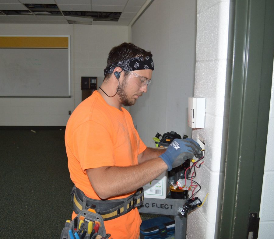 Ryan Clark of Complete Electrical Services, based in Fort Wayne, is removing light switches from one of the art rooms at Wawasee High School. The art rooms are among an extensive list of summer renovation or construction projects this year.