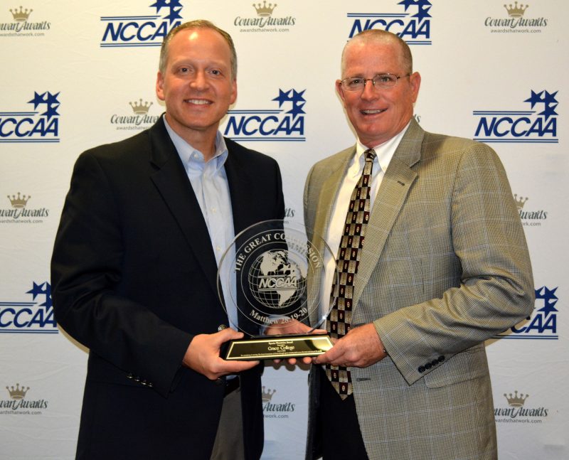 Grace College AD Chad Briscoe receives the NCCAA's Sports Ministries Award from NCCAA Executive Director Dan Wood (Photo provided)
