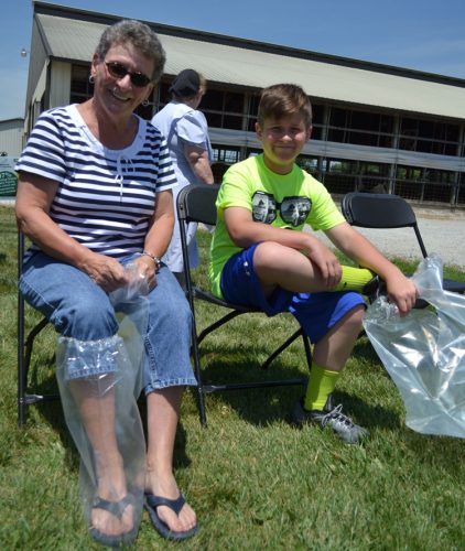 Lois Stackhouse and grandson Braden Shrock put on booties.