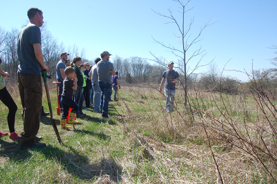 FUTURE FOREST — Casey Jones, right, ACRES director of land management, led a group of 20 Manchester University students and others for a day of tree planting at Wildwood Nature Preserve that saw around 200 trees put in the ground. Now is the perfect time to visit Wildwood, before mosquito season hits this diverse habitat of wetlands, forests and prairie. (Photo provided)