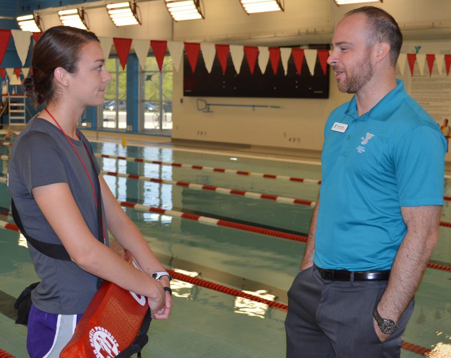 Steven Kuhn, right, chats with lifeguard Aletheia Burritt at the Parkview YMCA in Warsaw. Kuhn oversees the aquatics program at the Y.