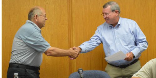 Town Attorney Vern Landis congratulates Larry Martindale after swearing him in as the new councilman. Martindale is representing Ward 4, replacing Brian Woody, who stepped down last month. (Photo by Lauren Zeugner)