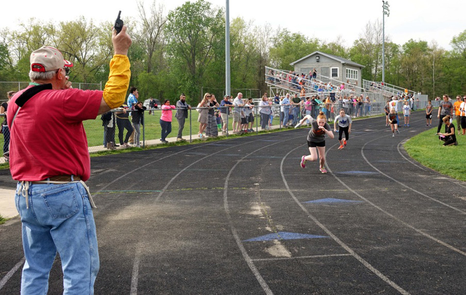 Noel Hoke works as a starter for a middle school track meet.