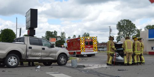 Firefighters from Turkey Creek Fire Territory cut the battery from a Buick Lucrene after a minor accident at Pickwick Drive and Huntington Streets in Syracuse today, Tuesday afternoon, June 7.