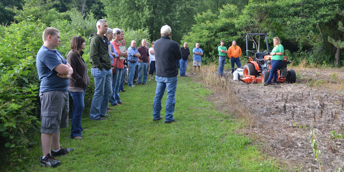 Andrea Baker of the SWCD and Koinonia Nature Preserve, far right, shows a piece of land that is being killed off in preparation for native species planting. (Photos by Amanda McFarland)