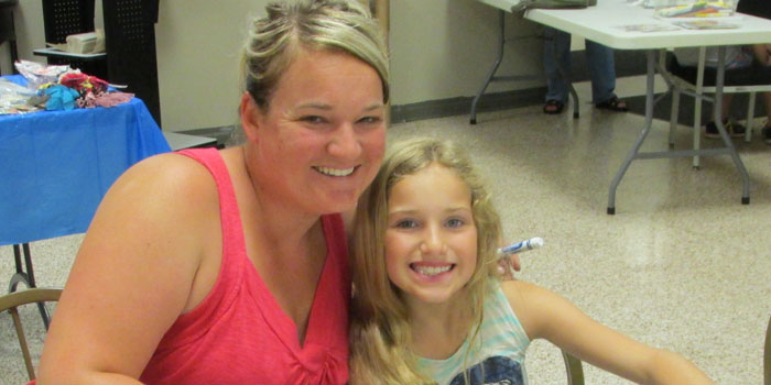 Mom Sara Dawn and her daughter Alyssa Kunish enjoy a round of Sports BINGO at the North Webster Library.