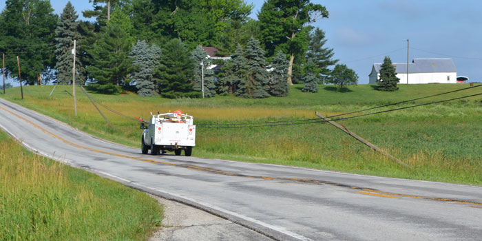 A worker assesses lines that are leaning across SR 14 just outside Silver Lake.