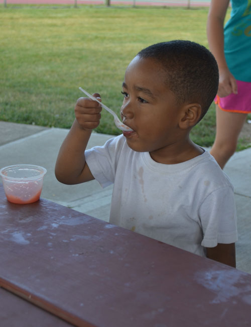 Kacin Wilson finishes off his strawberry applesauce.