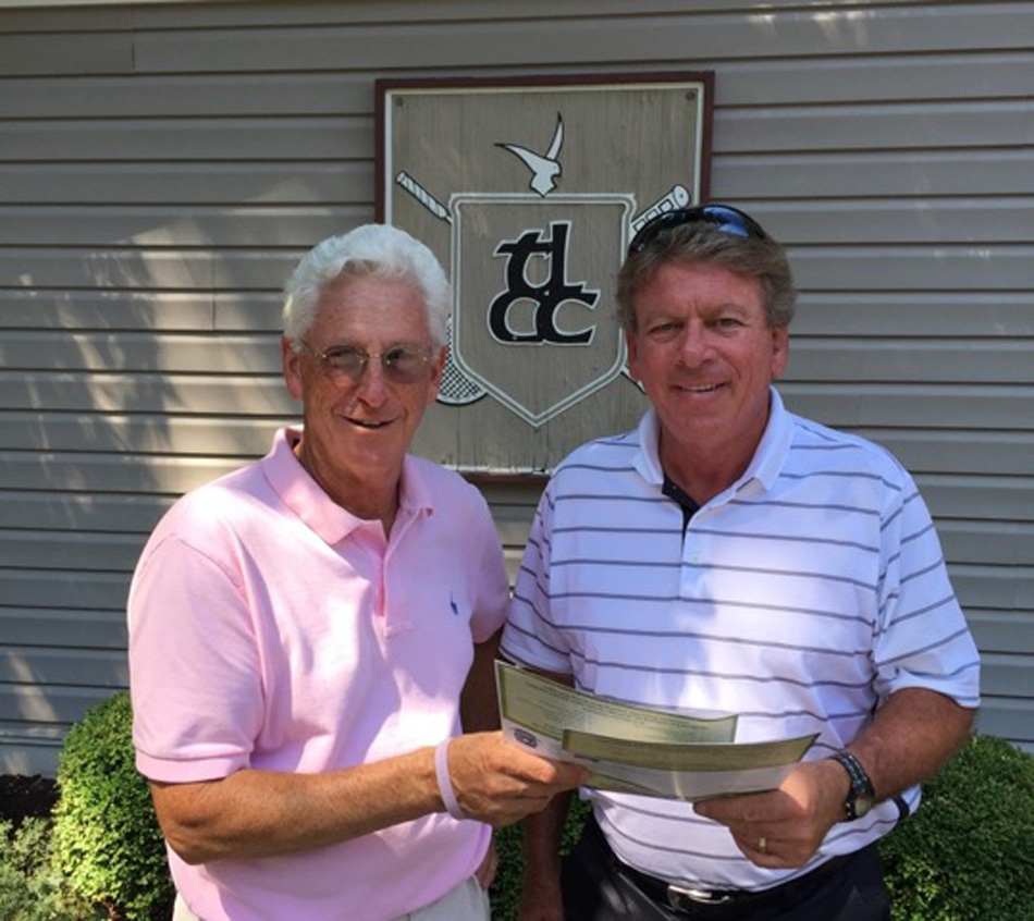 Ron Smock takes some of this year’s entry forms from the Kosciusko County Cancer Care Fund Golf Chairman, Denny Hively. The charity event will be on Monday, September 12. (Photo provided)