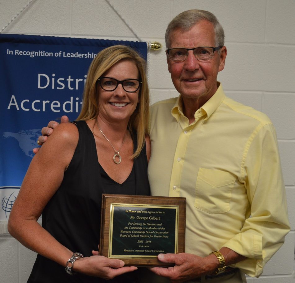 George Gilbert, right, was honored for his service on the Wawasee school board. He resigned after 12 years on the board. Shown with him is Rebecca Linnemeier, school board president.