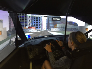 Macie Smith uses an emergency driving simulator at the ISP Career Camp.