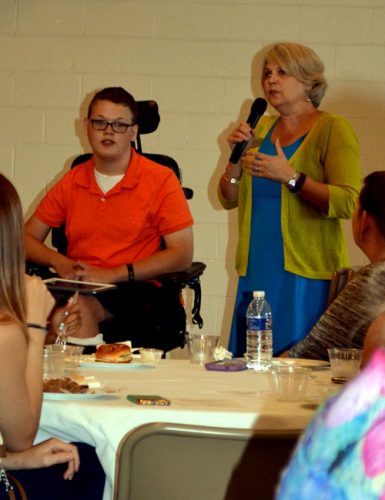 Moderator Lorinda Cline introduces speaker Mason Metzger.