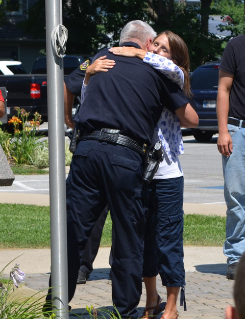 Chief Joe Hawn and organizer Courtney Jenkins hug following the prayer event.