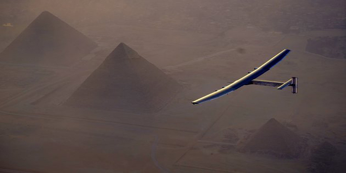 GIZA, EGYPT - JULY 13: Solar Impulse 2, the solar powered plane, flies above Giza Pyramids as Sun-powered aircraft finishes its penultimate flight, landing in Egypt on July 13, 2016 in Giza, Egypt. (Photo by Jean Revillard / Solar Impulse 2 / Pool/Anadolu Agency/Getty Images)
