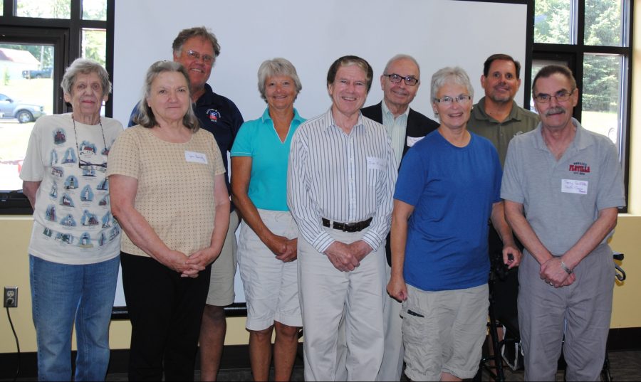 Awards were presented to the owners of some of the Lake Wawasee centennial cottages by the Syracuse-Wawasee Historical Museum during a program on the homes. In front, from left, are homeowners Jean Kennedy, Jim Fick, Karen Griffith and Terry Griffith. In back are Mary Lou Dixon, Ken Boles, Debby Leonard, Tim Needler and Dan Kiley. It is hoped recognition will encourage restoration of older homes rather than destruction.