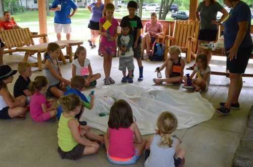 Kids participating in the Wetland Adventures for Kids build their own watershed and discuss issues concerning the watershed with Pam Schumm.