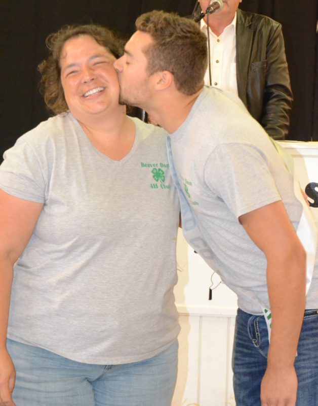 Conner Sausaman, right, 4-H King, gave the King's Kiss to Melinda Miller, mother of Kurt Miller.