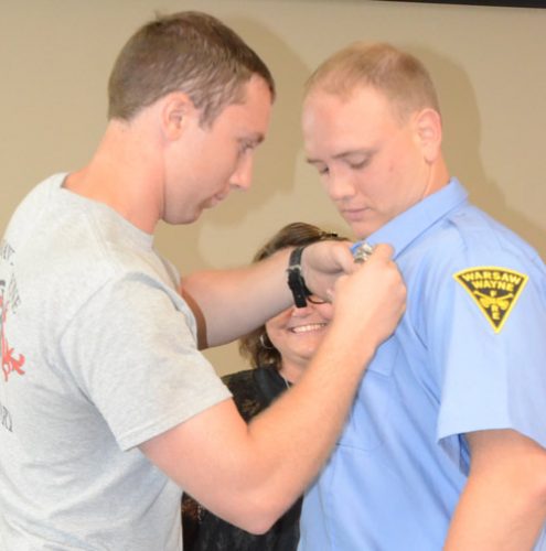 A fireman department tradition is having the pinning of the firefighter's badge. Trent Stamper, right, chose his brother Quin, a probationary firefighter, to do the honors.