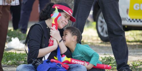 A mother and son show excitement as they wait for the torch parade in Sao Paulo. (Maggie Kenworthy | Ball State at the Games)