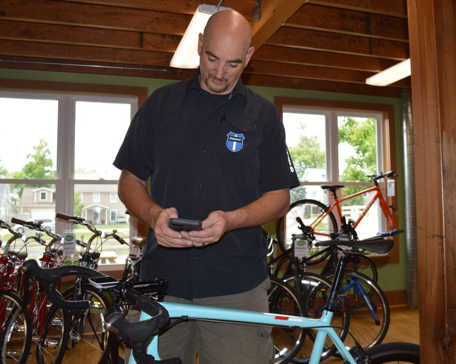 As demonstrated by Barry McManus, owner of Trailhouse Village Bicycles, using a smartphone is popular among bicycle enthusiasts to track mileage, speed and routes ridden.