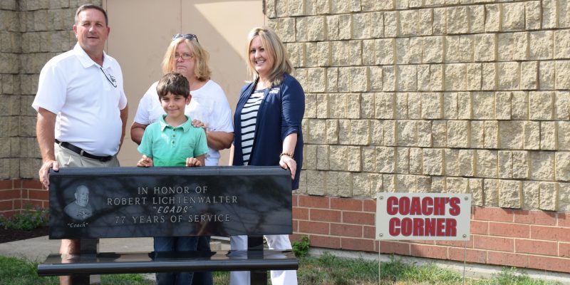 Tracy Furnivall, executive director, Judy Kinsey, Lichtenwalter's daughter, Tamara Drake, program director and Remi Iqbal, Lichtenwalter's great grandson all pose with the memorial being in Coach's Corner. (Photos by Maggie Kenworthy)